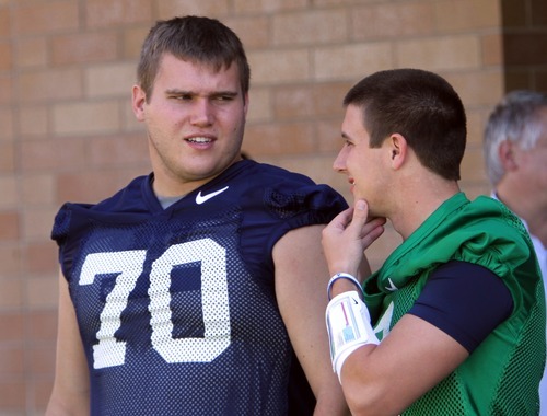 Rick Egan   |  The Salt Lake Tribune

Matt Reynolds (70) chats with BYU QB, Jake Heaps, before taking the field for the opening of Fall Football Camp at BYU, Saturday, August 6, 2011