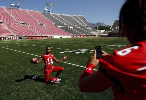 Trent Nelson  |  The Salt Lake Tribune
During a short break in a photo shoot, wide receiver Reggie Dunn hams it up for teammate Dres Anderson's camera. The University of Utah football team gathered for their team photo at Rice-Eccles Stadium in Salt Lake City, Utah. Saturday, August 6, 2011.