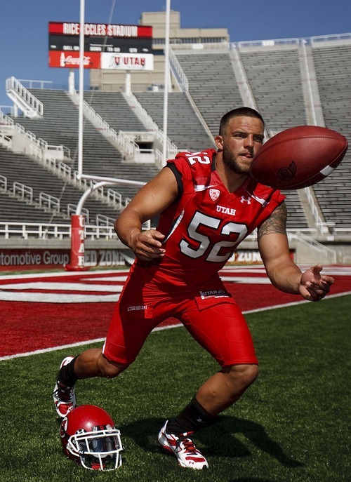 Trent Nelson  |  The Salt Lake Tribune
Linebacker Matt Martinez, right tosses the ball after posing for a photograph. The University of Utah football team gathered for their team photo at Rice-Eccles Stadium in Salt Lake City, Utah. Saturday, August 6, 2011.