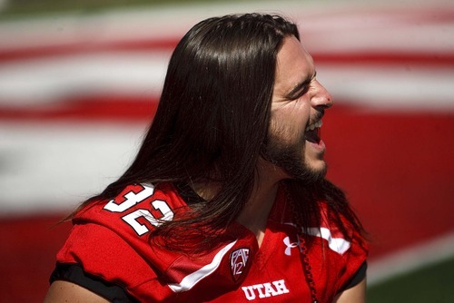 Trent Nelson  |  The Salt Lake Tribune
Linebacker Chaz Walker, provoked by his teammates, bursts out in laughter while posing for a photograph. The University of Utah football team gathered for their team photo at Rice-Eccles Stadium in Salt Lake City, Utah. Saturday, August 6, 2011.