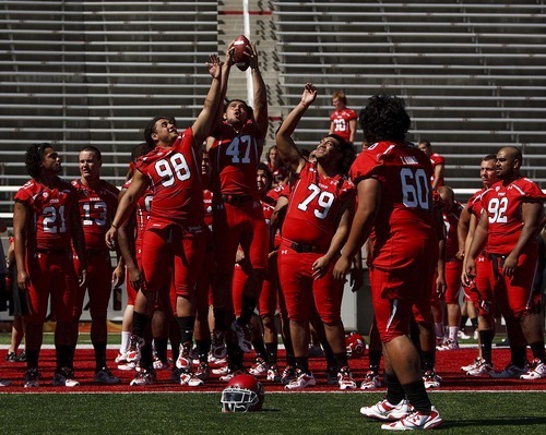 Trent Nelson  |  The Salt Lake Tribune
Players leap for the ball as the University of Utah football team gathered for their team photo at Rice-Eccles Stadium in Salt Lake City, Utah. Saturday, August 6, 2011.