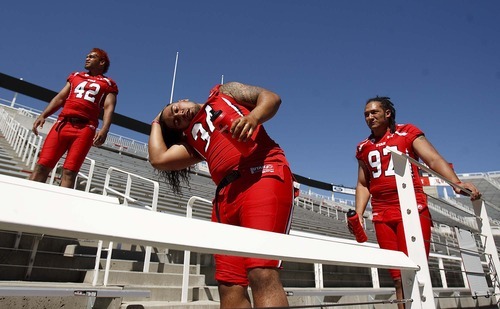 Trent Nelson  |  The Salt Lake Tribune
Players cool down with water as the University of Utah football team gathered for their team photo at Rice-Eccles Stadium in Salt Lake City, Utah. Saturday, August 6, 2011. At left, Nai Fotu and right is Tevita Finau. #34, center, unidentified on roster.