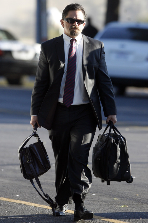 Defense attorney Deric Walpole, of McKinney, Texas, makes his way to the Tom Green County Courthouse, Monday, Aug. 8, 2011 in San Angelo, Texas for the 12th day of the sexual assault trial of Warren Jeffs.  Jurors convicted Jeffs last week of sexually assaulting two girls, ages 12 and 15, whom he'd taken as brides. He faces up to life in prison.  Jeffs has led the Fundamentalist Church of Jesus Christ of Latter Day Saints since 2002.  (AP Photo/ San Angelo Standard-Times, Patrick Dove)