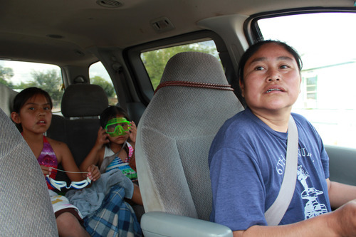 Gina Barker | The Salt Lake Tribune
Ophelia Gray drives her daughters Chenaoa, 6, and Kyara, 10, to
the pool. San Juan County families like Gray's are struggling to
budget for food over the summer months.