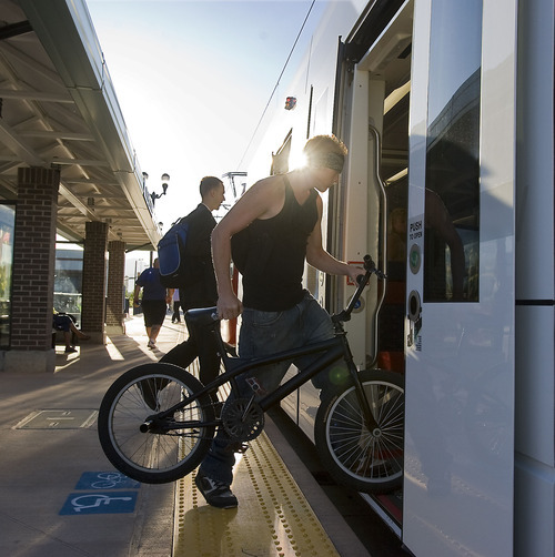 Al Hartmann  |  The Salt Lake Tribune
Passengers climb aboard an early morning TRAX train Monday, Aug. 8, 2011, at West Valley Central Station for the first workday operation of the new Green Line that runs from West Valley City Hall at 2750 West 3590 South all the way to Salt Lake City's Central Station at 600 West 250 South.