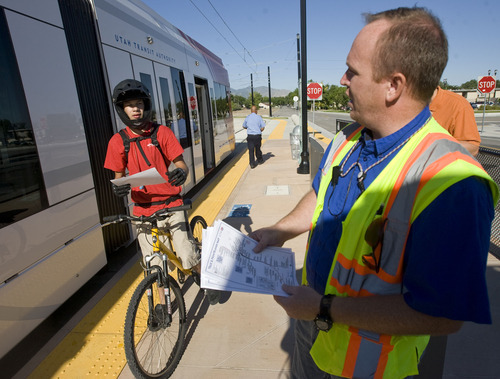 Al Hartmann  |  The Salt Lake Tribune
Pete Laubner, rail operation supervisor, right, hands out a route map to James Canas at the TRAX West Valley Central Station on Monday, Aug. 8, 2011, for the first workday operation of the new Green Line. Canas was on his way to the University of Utah. He could have taken the bus but decided to try the new TRAX line instead.