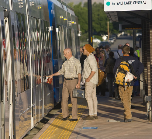 Al Hartmann  |  The Salt Lake Tribune
Passengers board an early morning TRAX train Monday, Aug. 8, 2011, at West Valley Central Station for the first workday operation of the new Green Line that runs from West Valley City Hall at 2750 West 3590 South all the way to Salt Lake City's Central Station at 600 West 250 South.