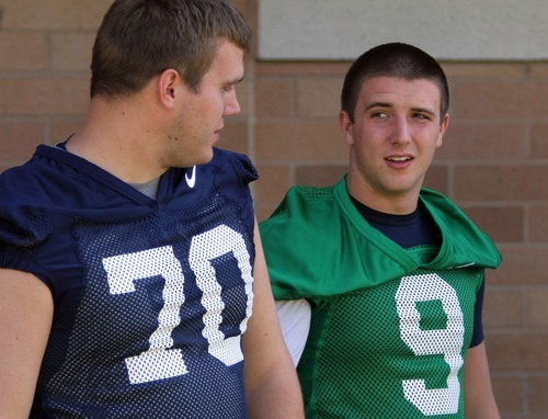 Rick Egan   |  The Salt Lake Tribune

Matt Reynolds (70) chats with BYU QB, Jake Heaps, before taking the field for the opening of Fall Football Camp at BYU, Saturday, August 6, 2011