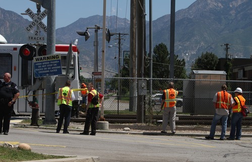 Rick Egan   |  The Salt Lake Tribune

A woman was hit by a TRAX train and killed as she was walking alongside the tracks at the intersection of 7200 South, Wednesday, Aug. 10, 2011.