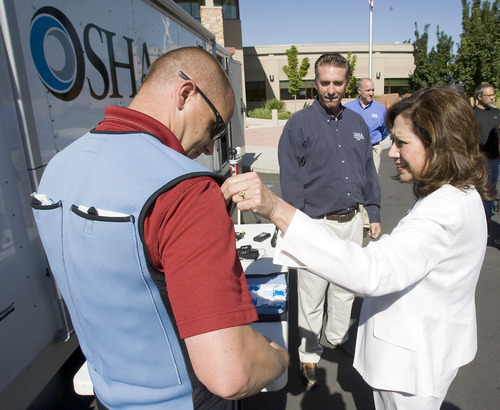 Al Hartmann  |  The Salt Lake Tribune
U.S. Secretary of Labor Hilda Solis, right,  checks out a neoprene cooling vest used in the field by Jedd Hill, a member of the Occupational Safety and Health Administration's Health Response Team. Solis toured OSHA's Technical Center on Thursday, promoting program to minimize heat-related illnesses on workers.