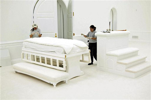 Authorities inside the FLDS temple at the Yearning for Zion Ranch in Eldorado collect evidence following a 2008 raid. Shown are temple beds. This photo was entered as evidence in the Warren Jeffs trial. Prosecutors alleged Jeffs had sex with underage child brides inside the temple and ordered construction of a table that could be transformed into a bed with a plastic-covered mattress. Courtesy Image