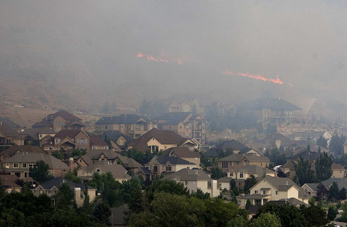 Trent Nelson  |  The Salt Lake Tribune
A fire burns near homes in Draper on Saturday.