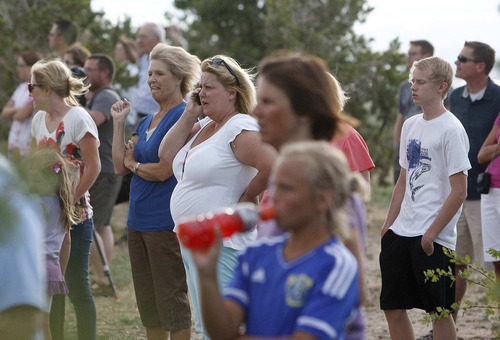 Trent Nelson  |  The Salt Lake Tribune
Onlookers watch as a  fire burns near homes in Draper on Saturday.