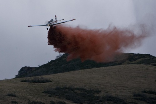 Djamila Grossman  |  The Salt Lake Tribune

An airplane drops fire retardant on flames of a fire that burns above homes in Draper, Utah, on Saturday, Aug. 13, 2011. The fire threatened several homes but destroyed none.