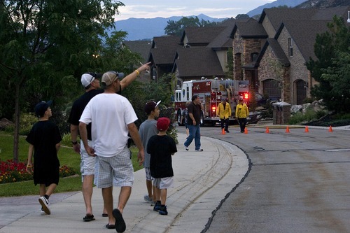 Djamila Grossman  |  The Salt Lake Tribune

Residents watch and walk the street as a fire burns in the hills above their homes in Draper, Utah, on Saturday, Aug. 13, 2011. The fire threatened several homes but destroyed none.