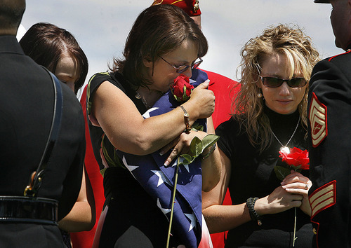 Scott Sommerdorf  |  The Salt Lake Tribune
Tracy Beede, the mother of Sgt. Daniel Gurr, hugs the flag that was presented to her by the Marine color guard at the graveside of her son in Vernal on Saturday. Gurr, 21, was killed by small arms fire while on patrol in the village of Malozai, Afghanistan.