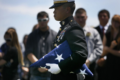 Scott Sommerdorf  |  The Salt Lake Tribune
A Marine holds a second flag to give to Dave Gurr, the father of Sgt. Daniel Gurr. The 21-year-old was killed by small arms fire while on patrol in the village of Malozai, Afghanistan.