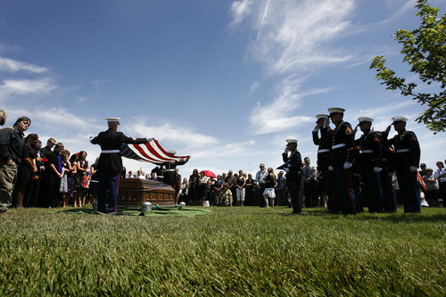 Scott Sommerdorf  |  The Salt Lake Tribune
Family members watch at left as the Marine honor guard handles the flag at the grave of Sgt. Daniel Gurr in Vernal on Saturday. Gurr, 21, was killed by small arms fire while on patrol in the village of Malozai, Afghanistan.