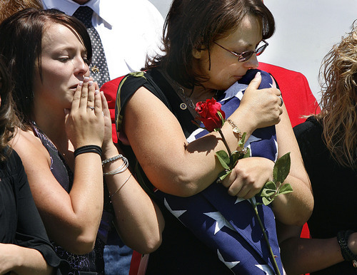 Scott Sommerdorf  |  The Salt Lake Tribune
Tracy Beede, the mother of Sgt. Daniel Gurr, hugs the flag that was presented to her by the Marine honor guard at the graveside of her son in Vernal on Saturday. Gurr's sister Caitlyn Gurr is at left. The 21-year-old Marine was killed by small arms fire while on patrol in the village of Malozai, Afghanistan.