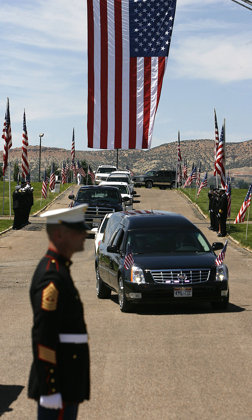 Scott Sommerdorf  |  The Salt Lake Tribune
The hearse brings the body of Sgt. Daniel Gurr to the Vernal Cemetery under a huge flag hoisted by the local fire department, Saturday. Gurr, 21, was killed by small arms fire while on patrol in the village of Malozai, Afghanistan.