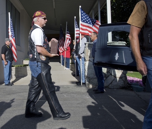 Al Hartmann  |  The Salt Lake Tribune
The Missing in America Project conducted its first mission in the State of Utah by honoring fifteen veterans whose remains have been in the care of Deseret Mortuary in Salt Lake City, UT, yet remained unclaimed.   Member of the Patriot Riders carries one of the boxes of cremated remains in a box to a watiting hearse that took the missing to Veterans Memorial Park at at Camp Williams for a ceremony and eventual burial.