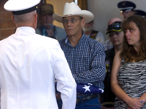 Al Hartmann  |  The Salt Lake Tribune
The Missing in America Project conducted its first mission in the State of Utah by honoring fifteen veterans whose remains have been in the care of Deseret Mortuary in Salt Lake City, UT, yet remained unclaimed.   
Navy honor guard gives folded flag of Ronald Hester to his brother Randall Hester during ceremony to honor the unclaimed remains during ceremony at Veterans Memorial Park.   Randall lost track of his brother and first heard of his brothers missing remains in an article in the Salt Lake Tribune.