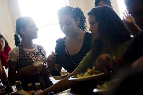 Djamila Grossman  |  The Salt Lake Tribune
From left, Zlatomira Nikolova, Maria Kabakova from Bulgaria and Sara Edwards load up their plates at the buffet table in the home of Debbie and Jay Beauregard in Bountiful on Aug. 7. This is the second year the Beauregards have been hosts for foreign visitors, including 12 people from Bulgaria this year.