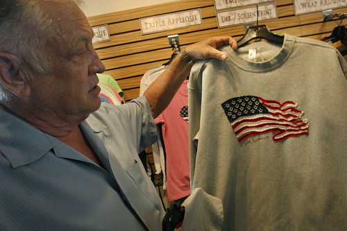 Scott Sommerdorf  |  The Salt Lake Tribune
SanSegal Sportswear President and founder Macon Rudick holds up one of the shirts made by his company, Thursday, July 21, 2011. SanSegal Sportswear manufactures a 