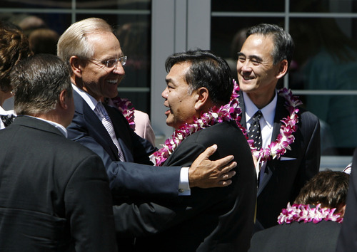 Francisco Kjolseth  |  The Salt Lake Tribune
Craig Zwick, left, of the Quorum of the Seventy of The Church of Jesus Christ of Latter-day Saints, embraces Ken Okazaki with his brother Robert Okazaki in background during funeral services for their mother Chieko Nishimura Okazaki, the first non-Caucasian member of any LDS general board or presidency, at the LDS Holladay South Stake Center on Wednesday, August 10, 2011.