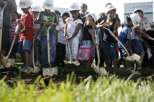 Margaret Distler  |  The Salt Lake Tribune 
Midvale Elementary School students help turn the dirt at the groundbreaking at the site of their new school at 7852 S. Pioneer Street on Aug. 3. The new 85,000 square foot school building is scheduled to open in fall 2012.