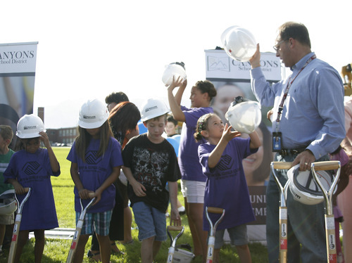 Margaret Distler  |  The Salt Lake Tribune 

David Doty, superintendent of Canyons School District, puts on a hard hat alongside members of the Midvale Boys and Girls Club at the groundbreaking of the new Midvale Elementary School at 7852 S. Pioneer Street on Aug. 3. Elementary students were invited to help turn the dirt at the site where the 85,000 square foot building is scheduled to open in fall 2012.