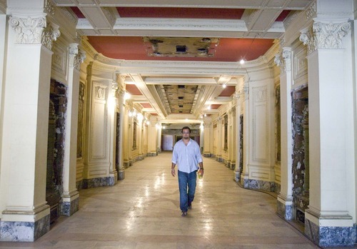Paul Fraughton  |  Tribune file photo
J.R. Howa, the son of Rick Howa, walks down the long entryway into the lobby of the Utah Theater on Salt Lake City's Main Street in July. The Salt Lake City Redevelopment Agency has agreed to buy the 1918-built playhouse for $5.5 million as part of a downtown cultural district. The theater could become a film center.