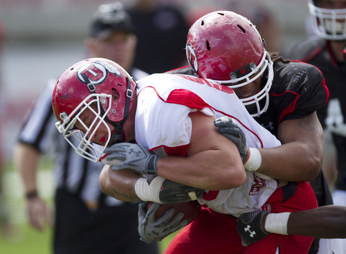 Lennie Mahler  |  The Salt Lake Tribune
Dallin Rogers is stopped by Tevita Finau during Utah football practice Monday, Aug. 15, 2011, at Rice-Eccles Stadium.