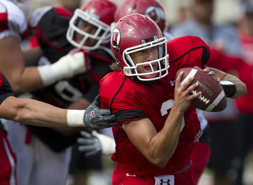 Lennie Mahler  |  The Salt Lake Tribune
Utah quarterback Jordan Wynn tries to evade defenders during practice Monday, Aug. 15, 2011, at Rice-Eccles Stadium.