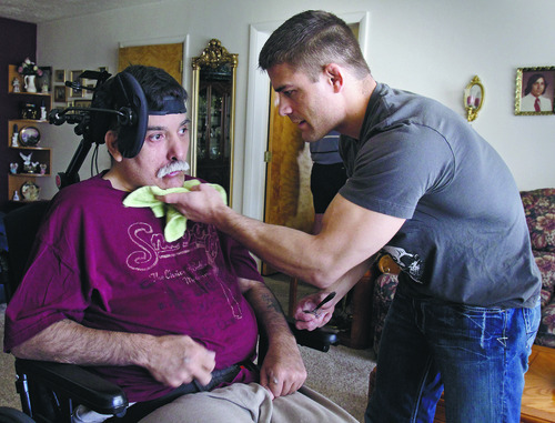 Rick Egan   |  The Salt Lake Tribune

 Rad Martinez gives his father some medicine at his home in West Jordan, Tuesday, August 9, 2011.  Martinez is a former college wrestler and rising star in mixed martial arts. he cares for his father, Richard, who sustained a severe brain injury in an auto accident some 12 years ago.