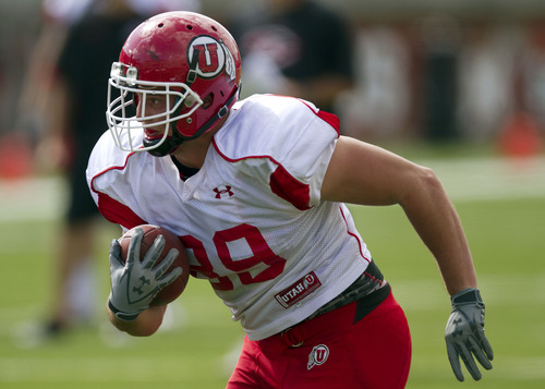 Lennie Mahler  |  The Salt Lake Tribune
Dallin Rogers rushes with the ball during Utah football practice Monday, Aug. 15, 2011, at Rice-Eccles Stadium.