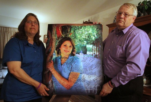 Rick Egan   |  The Salt Lake Tribune

Judy and Chuck Cox, mother and father of Susan Powell, hold a photo of Susan Powell, that has been signed by supporters, during an interview in their home in Puyallup, Washington,  Wednesday, November 3, 2010.