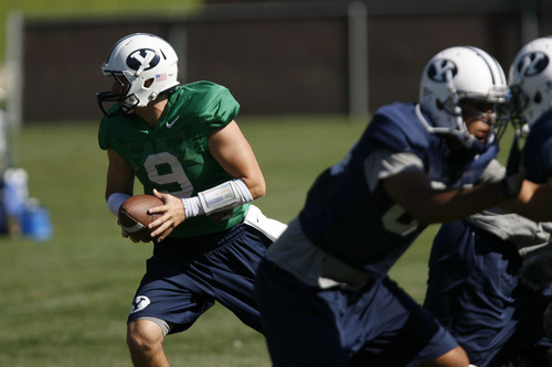 Francisco Kjolseth  |  The Salt Lake Tribune
Quarter back Jake Heaps looks for a handoff as BYU holds practice with many fans in attendance on their practice field on Tuesday, August 16, 2011.
