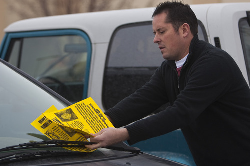 Photo by Chris Detrick  |  The Salt Lake Tribune 
Paul Timpson hands out 'missing person' fliers on cars in a Smith's parking lot Saturday December 12, 2009. Susan Powell, 28, was seen last Sunday at her home and was reported missing by her relatives the next day.