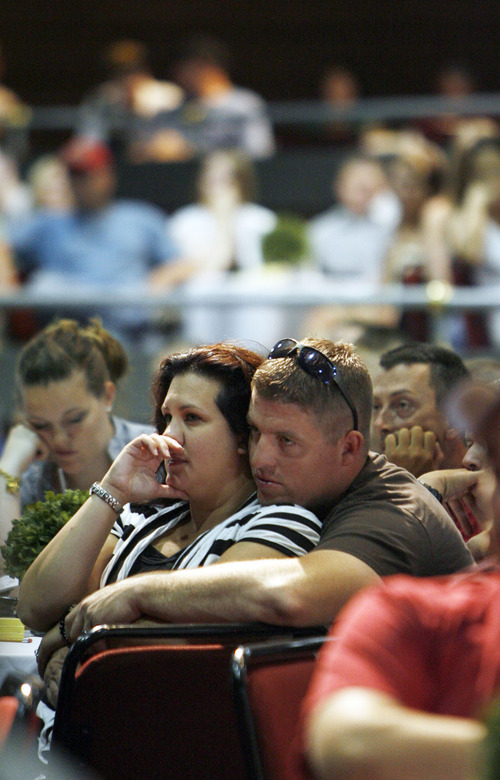Francisco Kjolseth  |  The Salt Lake Tribune
Sgt. Randy Harmon, of South Jordan, along with his wife, Noelia, listen with other members of the first of the 211th aviation unit of the Utah National Guard during a meeting in Lehi on Saturday of their September deployment to Iraq falling through, although orders were still tentative. Due to the political landscape in Iraq, that deployment has now been pushed off until 2013. But some members of this unit had already quit jobs in order to deploy. This affects nearly 400 soldiers and their families. On Saturday at 9 a.m. Major General Brian Tarbet, the Adjutant General of the Utah National Guard, met with soldiers, their families and employers to try to take care of any fallout that could occur from the change in plans.