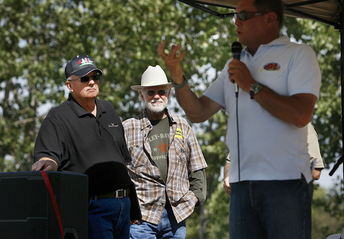 Scott Sommerdorf  |  The Salt Lake Tribune
Rep. Mike Noel, R-Kanab, and retired Kane County Commissioner Mark Habbeshaw, right, listen as their efforts as advocates for the open roads issue are lauded at the state Fairpark on Saturday.