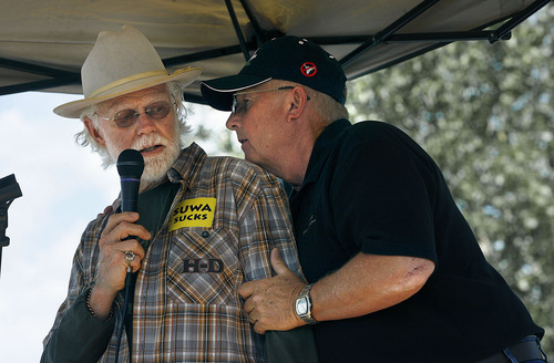 Scott Sommerdorf  |  The Salt Lake Tribune
Rep. Mike Noel, R-Kanab, right, leans over to tell retired Kane County Commissioner Mark Habbeshaw to cut short his remarks because the governor has just arrived. Open roads activists rallied at the State Fairpark for speeches, and then drove to the State Capitol Saturday.