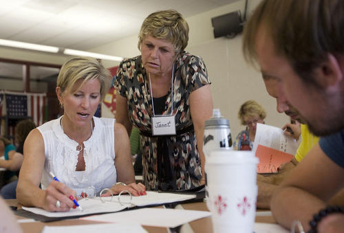 Al Hartmann  |  The Salt Lake Tribune
Trainer Janet Sutorius, center, helps Andrea Payne, an eighth- and ninth-grade math teacher at Treasure Mountain Middle School, during a teacher training class in July at Park City HIgh School. A new math class will replace Algebra 1 and is the first part of the statewide phase-in of the Common Core, new academic standards in math and language arts.