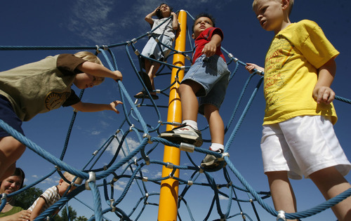 Francisco Kjolseth  |  The Salt Lake Tribune
Students at the Jean Massieu School of the Deaf and their siblings celebrate the unveiling of a new playground. Last week, vandals painted the playground with blue graffiti, but community volunteers cleaned up the $155,000 playground before the unveiling on Monday, Aug. 22, 2011. Kids at the school pitched in $55,000 through fundraising to make it all happen.