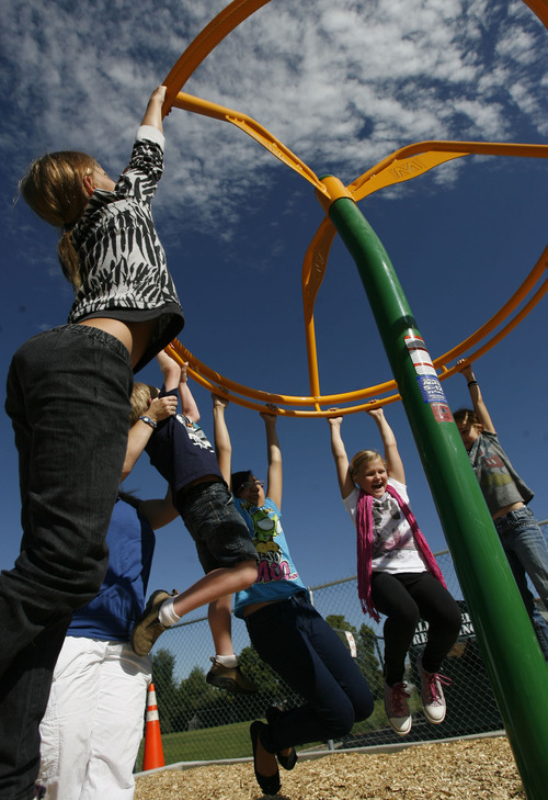 Francisco Kjolseth  |  The Salt Lake Tribune
Students at the Jean Massieu School of the Deaf celebrate the unveiling of a new playground. Last week, vandals painted the playground with blue graffiti, but community volunteers cleaned up the $155,000 playground before the unveiling on Monday, Aug. 22, 2011. Kids at the school pitched in $55,000 through fundraising to make it all happen.