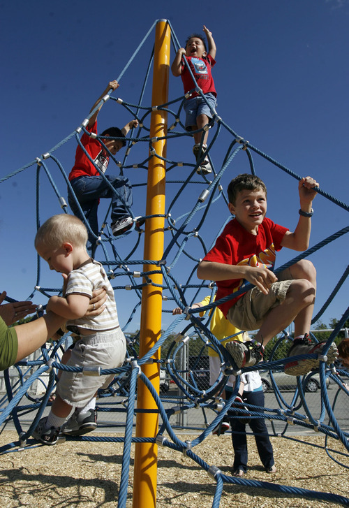 Francisco Kjolseth  |  The Salt Lake Tribune
Students at the Jean Massieu School of the Deaf celebrate the unveiling of a new playground. Last week, vandals painted the playground with blue graffiti, but community volunteers cleaned up the $155,000 playground before the unveiling on Monday, August 22, 2011. Kids at the school pitched in $55,000 through fundraising to make it all happen.
