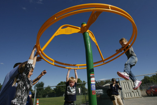 Francisco Kjolseth  |  The Salt Lake Tribune
Students at the Jean Massieu School of the Deaf celebrate the unveiling of a new playground. Last week, vandals painted the playground with blue graffiti, but community volunteers cleaned up the $155,000 playground before the unveiling on Monday, August 22, 2011. Kids at the school pitched in $55,000 through fundraising to make it all happen.