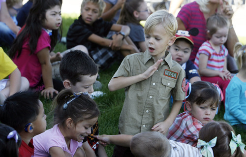 Francisco Kjolseth  |  The Salt Lake Tribune
Jaden Goff, 5, a student at the Jean Massieu School of the Deaf celebrate uses sign language to speak with his classmates as they wait for the unveiling of a new playgroundat their school. Last week, vandals painted the playground with blue graffiti, but community volunteers cleaned up the $155,000 playground before the unveiling on Monday, August 22, 2011. Kids at the school pitched in $55,000 through fundraising to make it all happen.
