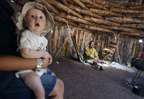 Scott Sommerdorf  |  The Salt Lake Tribune
Seven-month-old Elijah Daley on vacation with his family from Texas, visits the Hogan at the Indian Village at This is The Place Heritage Park on July 29.