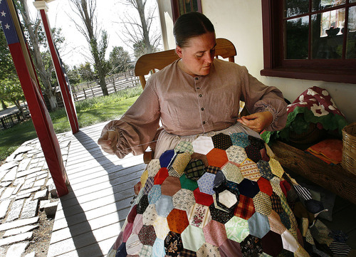 Scott Sommerdorf  |  The Salt Lake Tribune
Bette Bohman sits on the porch of the Andrus Inn making a quilt at This is The Place Heritage Park on Thursday.